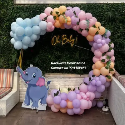 This is a fun and modern baby shower ring decoration perfect for outdoor or indoor parties. The pastel balloon garland is accented with a cute elephant cutout and a golden 'Oh Baby!' sign in the center.