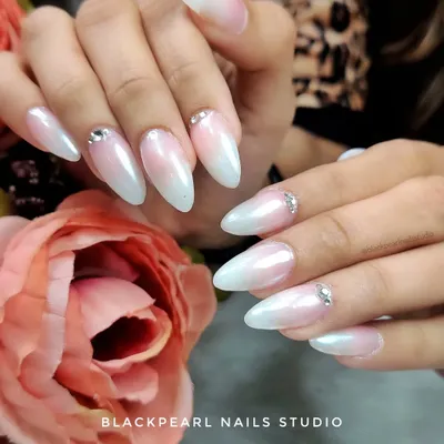 The ultimate bridal nails. This set features a classic baby boomer ombré with a pearl chrome finish and delicate Swarovski crystal accents for a touch of timeless glamour.