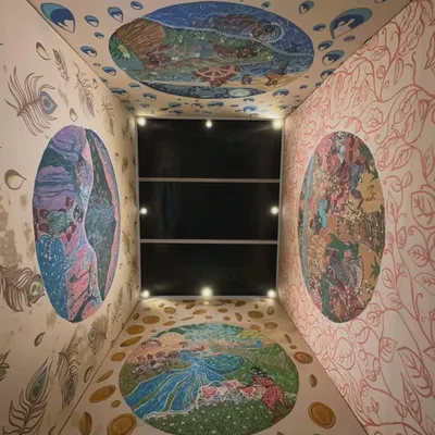 An overhead view of the completed "Thinai Project" installation at night. The four paintings represent Kurinji (mountains), Mullai (forests), Marudham (farmlands), and Neidhal (coast), creating a complete world within the room.