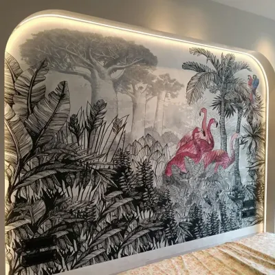 We brought a tropical retreat indoors with this custom bedroom wallpaper. The design features a dramatic, hand-drawn jungle scene in monochrome, with vibrant pink flamingos creating a stunning pop of color. The arched headboard with custom lighting makes it a true centerpiece.