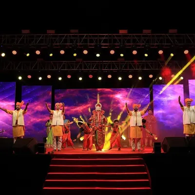 For the 'Aai Gavdevi' new song release, I constructed a large-scale outdoor stage. The setup included multiple LED screens for visuals, a full concert lighting rig, and a tiered stage to accommodate all the performers for a grand presentation.