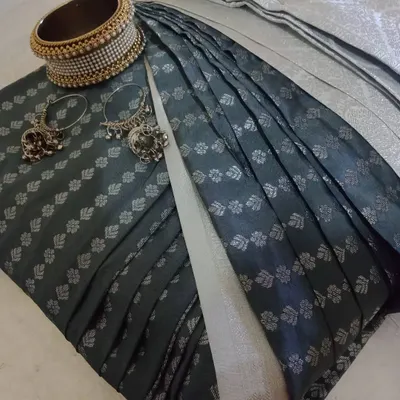 A beautifully pre-pleated and folded dark green saree, ready to be delivered. I've paired it with some jewelry to show how you can style it.