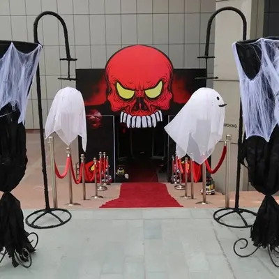 A powerful and spooky entrance designed for a Halloween event. The giant red skull, floating ghosts, and red carpet immediately set a haunted, high-impact tone.