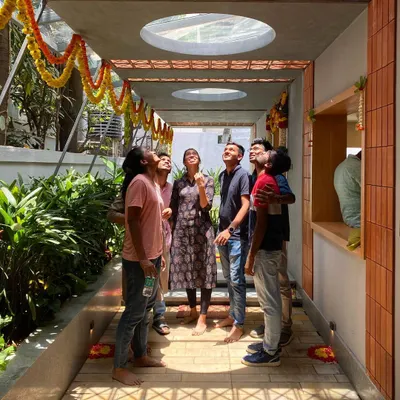 Our team stands in the spotlight of a circular skylight at a recently completed project. This entryway was designed to track the sun's movement, creating a moving circle of light that brings a sense of ritual to daily life.