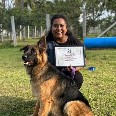 This was a dream come true. Here I am with my girl Bella, holding my professional dog trainer certification. I am proud to use my education to help you and your dog.