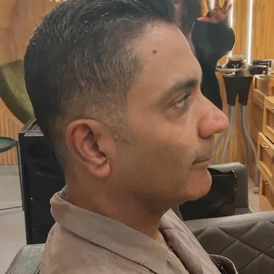 A side profile view showcasing the clean lines and seamless blend of a classic men's haircut. Precision is key to a style that looks great from every angle.