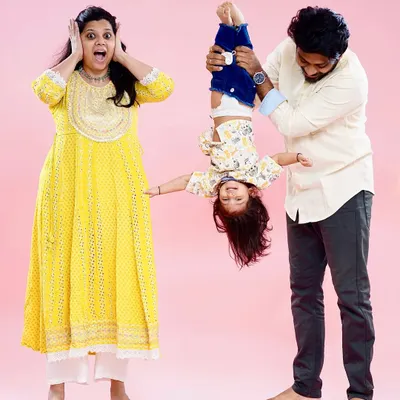 We love capturing the fun and chaos of family life. This playful shot of a dad holding his son upside down while mom reacts is a perfect example of a real, unscripted family moment.
