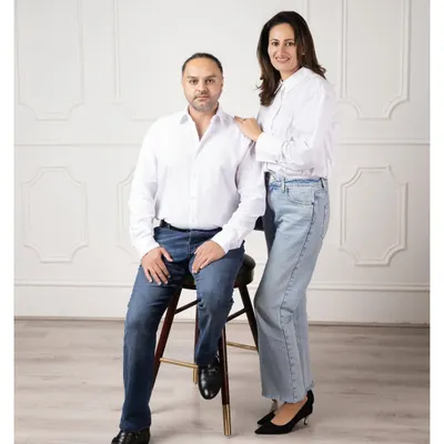 A classic and clean studio portrait for a couple. The simple white shirts and relaxed poses create a timeless image that focuses purely on their connection.