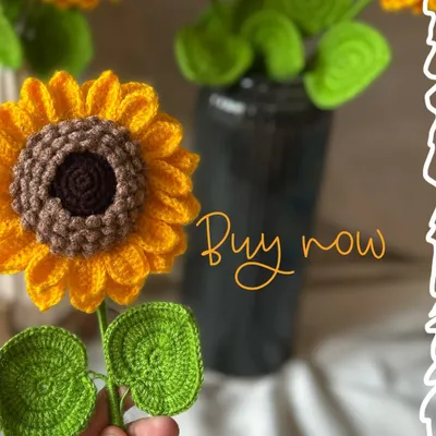 A single, handcrafted crochet sunflower, perfect for adding a pop of sunshine to any vase. The intricate details in the petals and center are all done by hand.