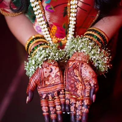A beautiful shot of a baby shower mehndi with a rich, dark stain. The design includes a baby sleeping under the moon, celebrating the new life to come.