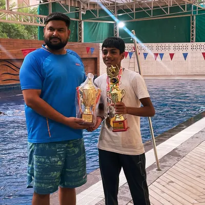 Celebrating another "Best Swimmer of the Meet" title for Aryaman Suri. Here we are poolside with his well earned trophies from the NCR Open Swimming Meet. His consistent victories are a direct result of his dedication and our structured training program.