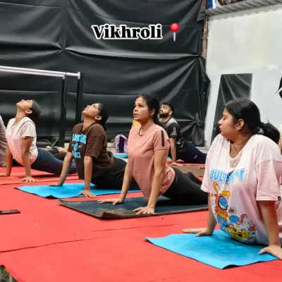 A group of our members in the cobra pose during a flexibility session. This is essential for improving spinal mobility and preventing back pain.