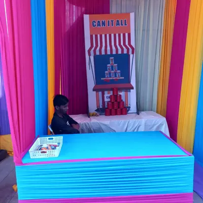 A classic 'Can It All' tin can toss stall, perfect for bringing a carnival feel to your event. I provide the complete setup with the stall, backdrop, and game materials.