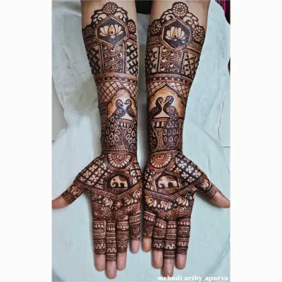 A beautiful pairing of two classic motifs. This design features elegant peacocks on the forearms and small, charming elephants on the palms, creating a story of grace and strength.