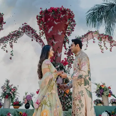 A picture-perfect moment for Shree and Mohnish. They are both wearing custom Rahul Mishra outfits, with his floral kurta perfectly complementing her pastel lehenga.