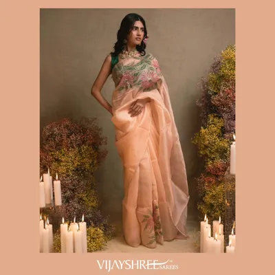 Perfect for a daytime event, this peach silk organza saree features stunning handmade floral embroidery, offering a light and ethereal look.