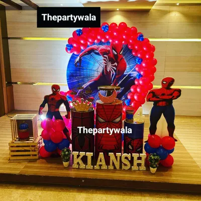 A powerful Spiderman theme for a 4th birthday celebration. The setup features a large character backdrop, themed pedestals, and balloon columns, creating an immersive superhero experience.