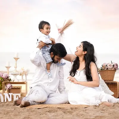 Pure joy and laughter on the beach. A father lifts his son onto his shoulders as mom looks on with a smile. These are the candid, happy memories we love to freeze in time.
