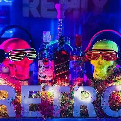 The centerpiece of my Retro Rewind bar. A light-up 'RETRO' sign is flanked by two colorful skulls wearing headphones and neon shutter shades, perfectly capturing the fun and funky vibe of the 80s.