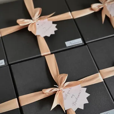 "Will you be my Bridesman?" These sleek black boxes with peach ribbons are perfect for asking the special guys in your life to be part of your wedding day.