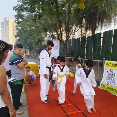 Taking our training outdoors. A young student practices on an agility ladder during our session at the Malad Masti event, showing that we can build skills anywhere.