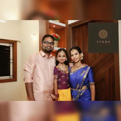 A beautiful family portrait. I had the pleasure of designing a matching embroidered blouse for the daughter, coordinating perfectly with her mother's royal blue saree.