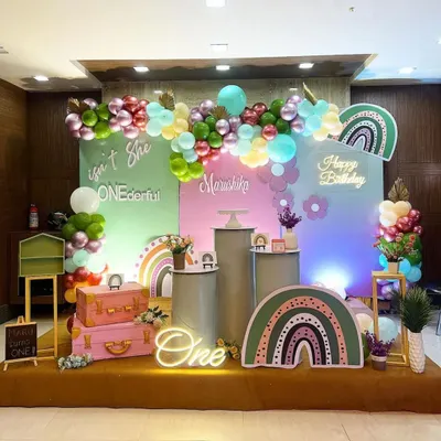 A "ONEDERFUL" first birthday featuring a trendy boho rainbow theme. I used a muted color palette with custom rainbow props, pampas grass, and a neon sign to create a stylish and sweet celebration.