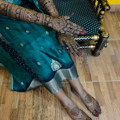 A full bridal look with intricate mehendi on both hands and feet, perfect for the bride who wants complete adornment.
