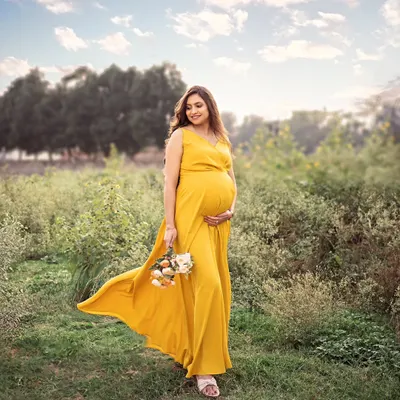 A moment of pure elegance and timeless beauty captured on a serene Bangalore evening. The warm, golden glow caresses the expecting mom-to-be, creating an unforgettable story.