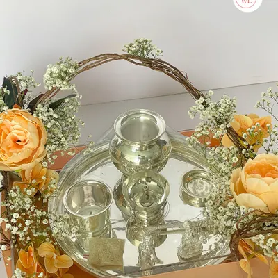 A detailed view of the silver items from my traditional hamper. This set includes a silver-plated lota, glass, and diya, which are not just beautiful but also hold cultural significance, making them a very thoughtful gift.