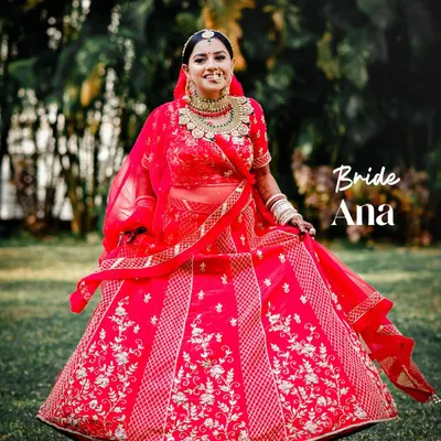 A beautiful twirling shot of the bride in her vibrant red lehenga. We love creating dynamic portraits that show off the beauty and movement of your wedding dress.