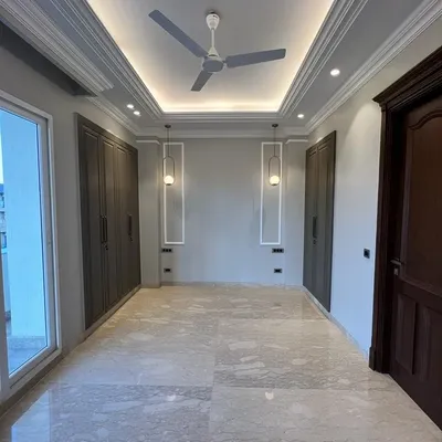This bedroom at C-257 is a perfect example of minimal luxury. The clean lines, marble flooring, and subtle pendant lights create a serene and calming atmosphere, perfect for rest.