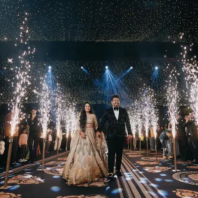 A grand entrance for a grand beginning. We love capturing the spectacle of an engagement night, with sparklers lighting the way for the happy couple, creating a truly cinematic and unforgettable moment.
