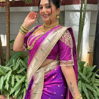 A joyful Maharashtrian look for my client, featuring a classic updo, a traditional nath, and a beautiful purple Paithani saree. Her smile says it all.