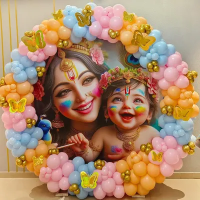 This Krishna-themed baby shower was a divine celebration. I created a circular backdrop featuring a beautiful illustration of Yashoda and Krishna, framed by a vibrant garland of pastel pink, blue, and orange balloons with golden butterfly accents. It was a unique and blessed event for the mom-to-be.