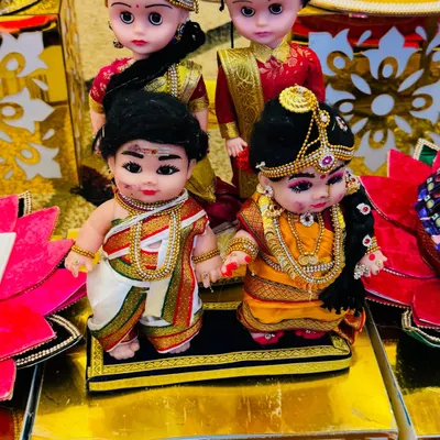 A close-up of my adorable couple dolls, dressed in traditional South Indian attire for a wedding ceremony. The detailing on their clothes and jewelry is what makes them so special.