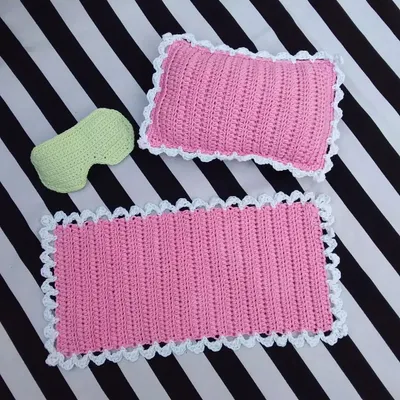 This set was a special custom order I made. It includes a miniature pink crochet blanket with a white scalloped edge, a matching pillow, and a tiny green eye mask. I really enjoy working on custom projects like this to bring your ideas to life.