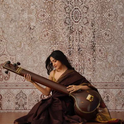Seated with my tanpura, the instrument that provides the foundational drone for Indian classical practice. This posture and connection to the instrument are central to 'riyaaz' and help in developing a keen sense of pitch and resonance.