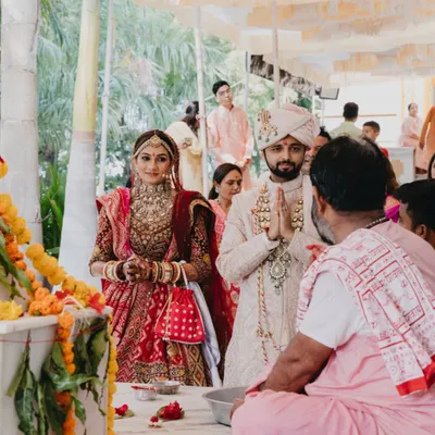 The couple seeking blessings from a priest at a temple. I can arrange for ceremonies in sacred spaces to add a layer of spiritual depth to your union.