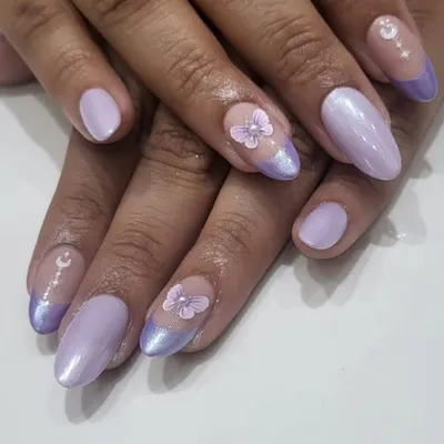 A whimsical and dreamy design. This set features a lavender French tip, pearlescent polish, and delicate, hand-sculpted 3D butterflies and moon charms.