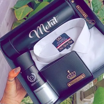 A classic combination for any man. This hamper features a crisp white Tommy Hilfiger shirt, a personalized leather wallet, a name-engraved flask, and a Denver deodorant, all ready to gift.