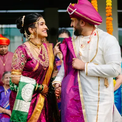 A candid glance between the bride and groom during their Maharashtrian wedding ceremony. These unscripted interactions are the heart of your wedding story.