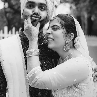 I love capturing these silly, playful moments. Her joyful expression as she squishes his face is pure, unscripted fun, and it tells you so much about their relationship.