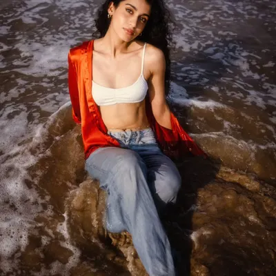A serene moment with the waves washing over. This shot is all about the connection with nature, capturing a peaceful and therapeutic beach vibe.