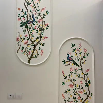 A full view of the peacock and lemon tree mural painted within two arched frames. This design brings a touch of nature and traditional elegance to a modern home.