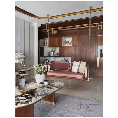 The living room of Crescendo House, where each room was designed with a unique personality. This space features a custom reversible swing, luxurious marble, and rich wood paneling, creating a grand yet inviting atmosphere.