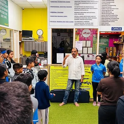 I am addressing a group of young shooters before a competition. A coach's role is not just to teach technique, but to build the confidence needed to perform under pressure.