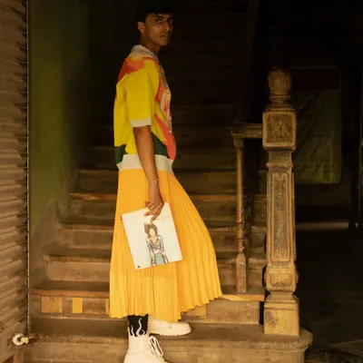 This fashion editorial shot was taken on the streets of Dadar market. I'll teach you how to direct a model with confidence in a crowded public space and how to edit the image to make the colorful outfit pop against the gritty background.