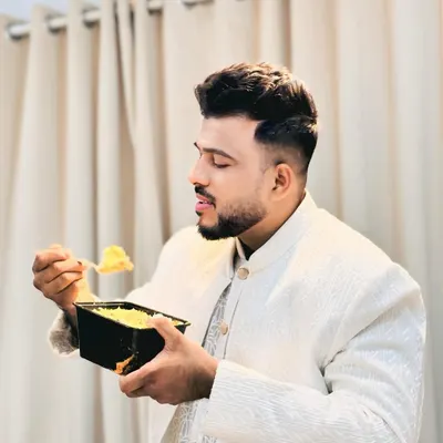 A true biryani lover enjoying our special Chicken White Biryani. It's a more delicate and fragrant version of the classic dish.