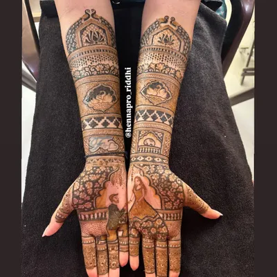 A beautiful engagement henna design capturing the moment he proposed. The portrait work on the palms is surrounded by intricate patterns, making the story the centerpiece of the art.